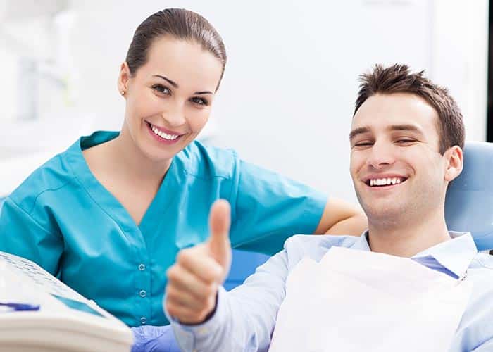 Dental patient giving thumbs up